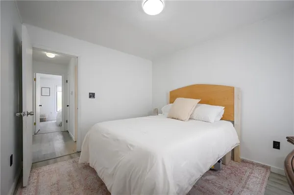 a bedroom with a bed and a lamp