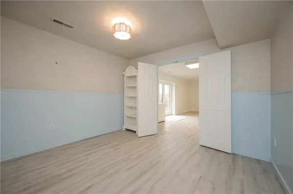 wooden floor in an empty room with a window