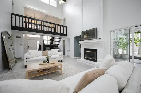 a living room with furniture a flat screen tv and a fireplace