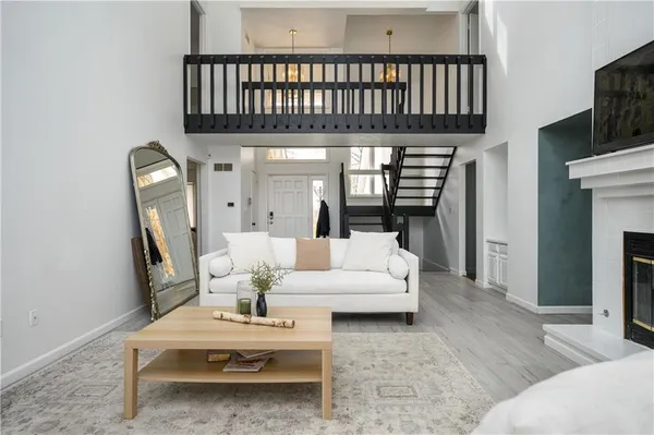 a living room with furniture a fireplace and a flat screen tv
