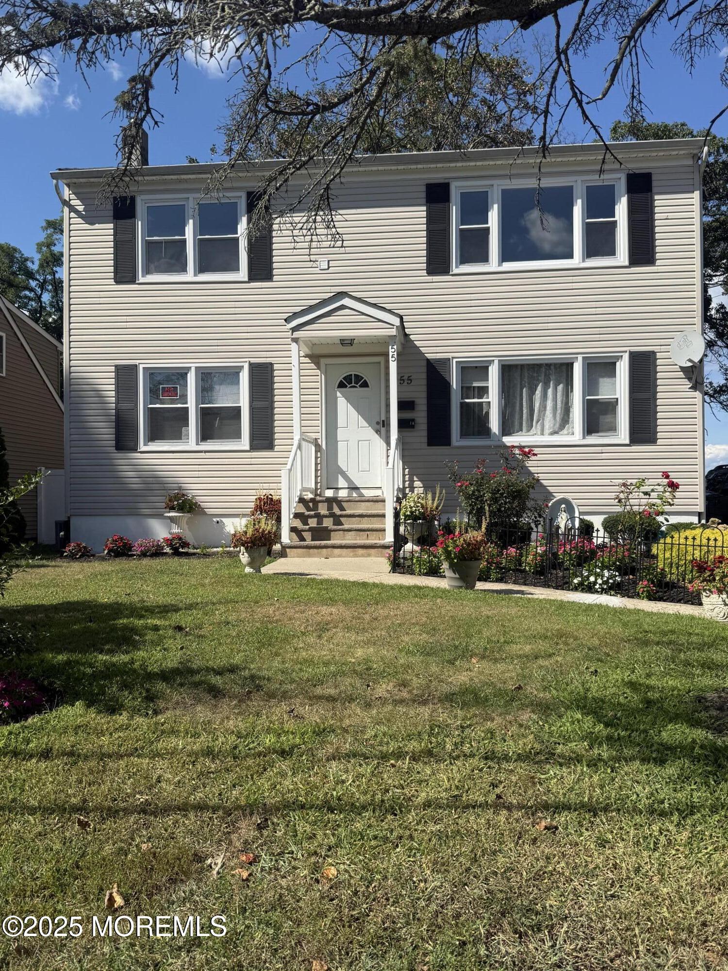 55 Chapin Avenue, Unit 2 Red Bank, NJ 07701 - Photo 1 of 13 a front view of a house with a garden