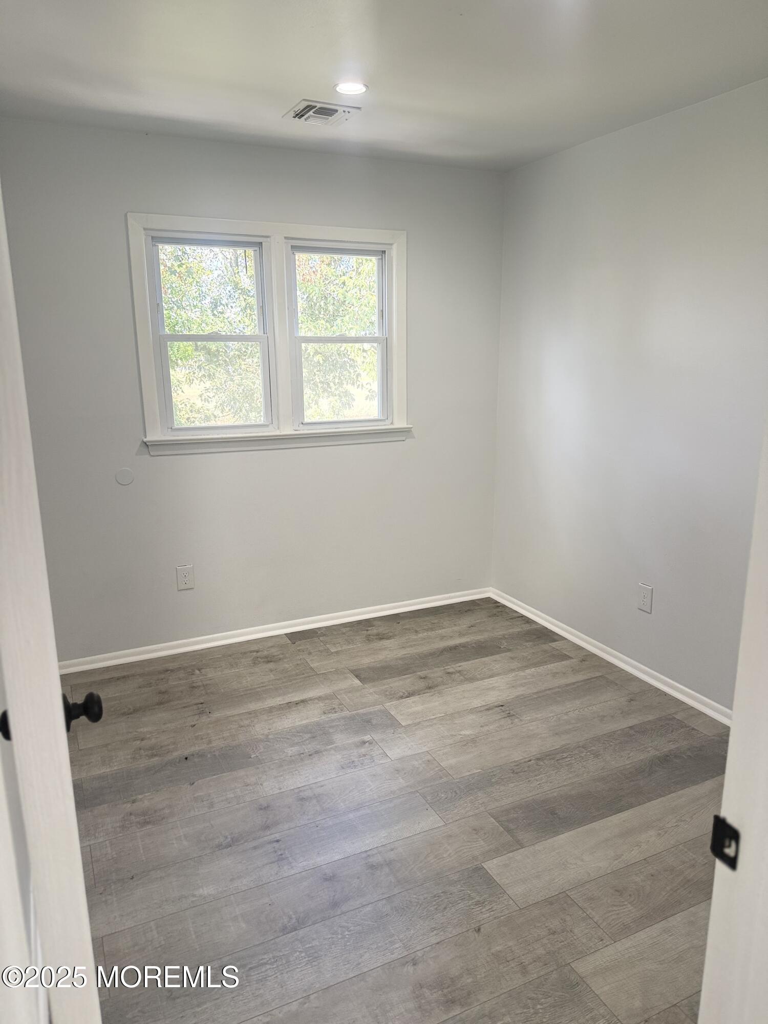 55 Chapin Avenue, Unit 2 Red Bank, NJ 07701 - Photo 6 of 13 an empty room with a window