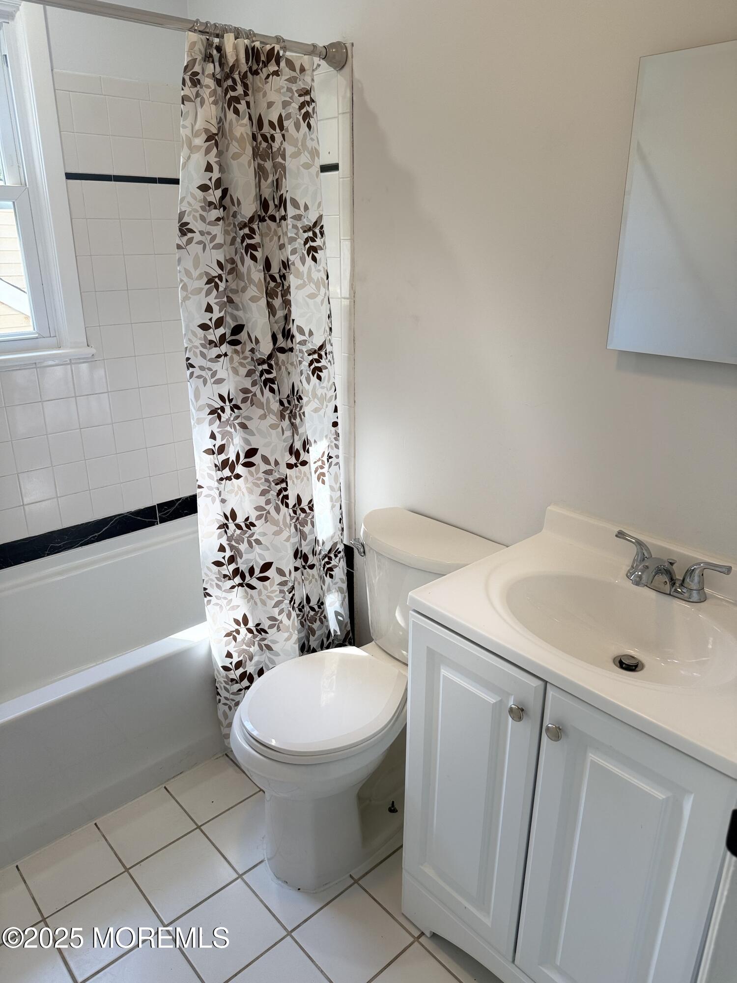 55 Chapin Avenue, Unit 2 Red Bank, NJ 07701 - Photo 8 of 13 a white toilet sitting next to a bathroom sink and tub