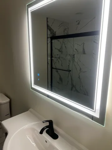 a bathroom with a sink and mirror