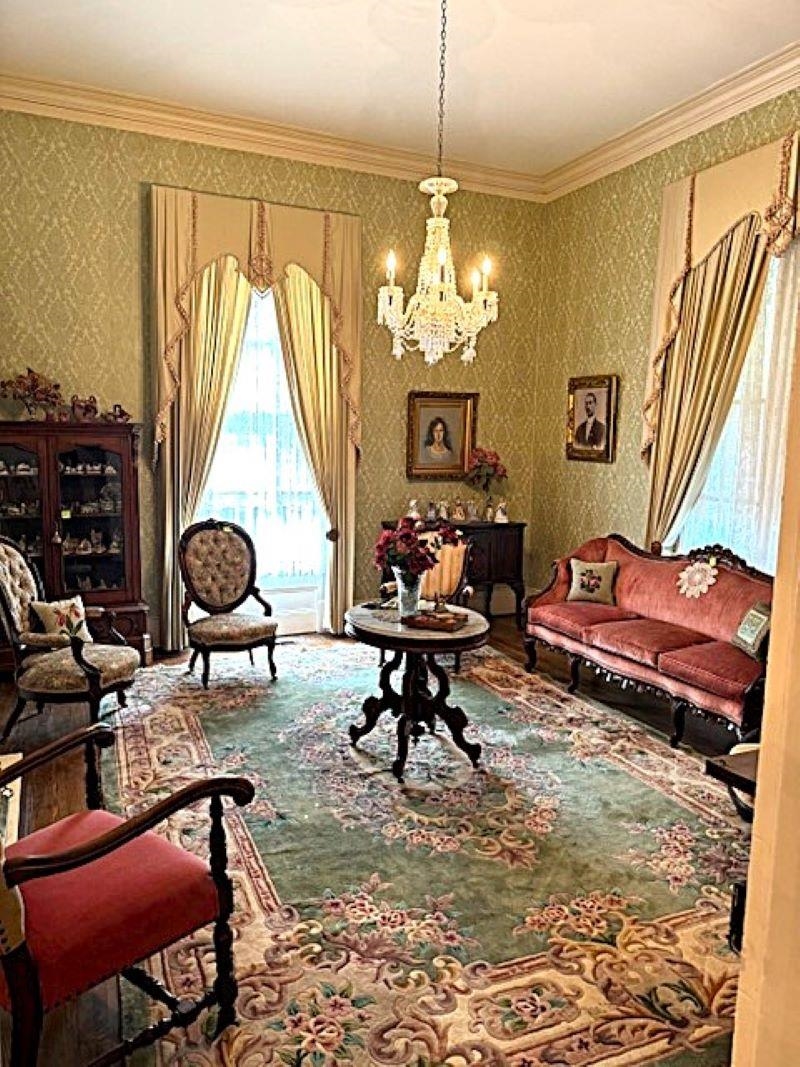 23840 Highway 57 La Grange, TN 38046 - Photo 10 of 15 Living/parlor room featuring a notable chandelier and crown molding, fireplace