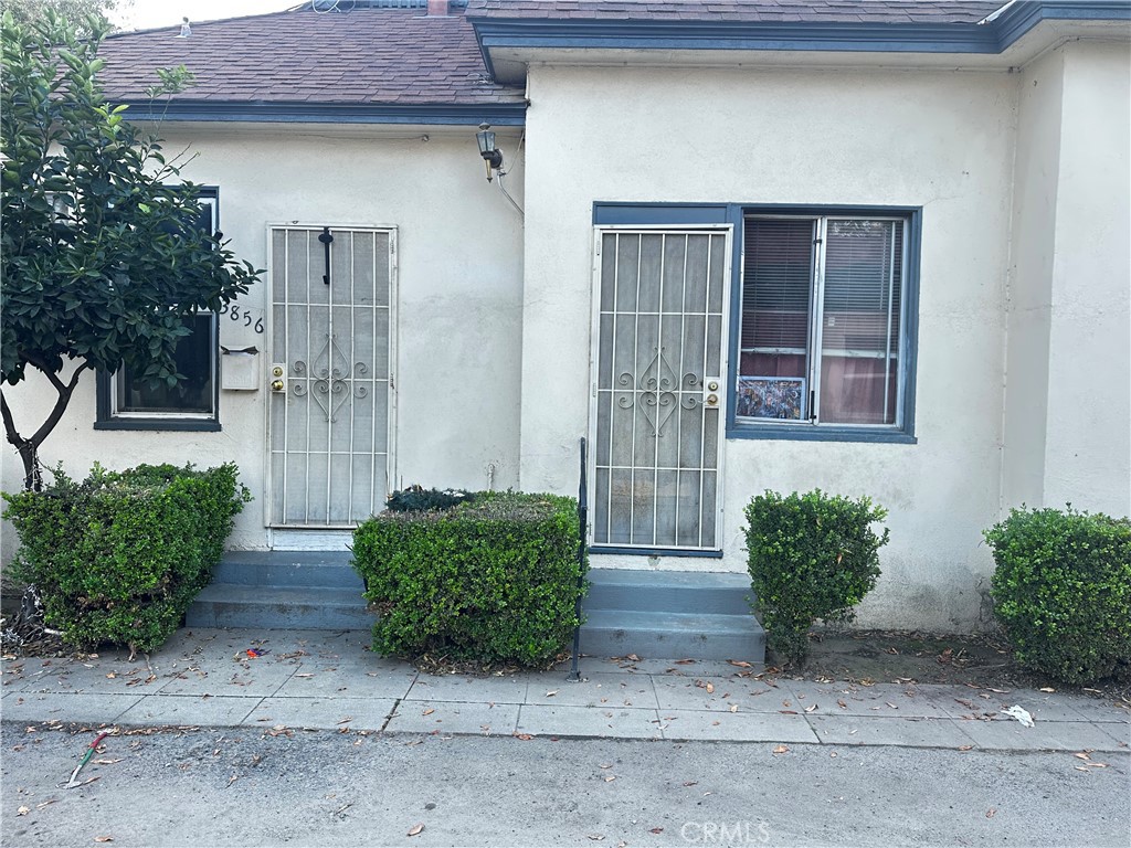 3848 Locust Street Riverside, CA 92501 - Photo 3 of 6 a front view of a house with garden