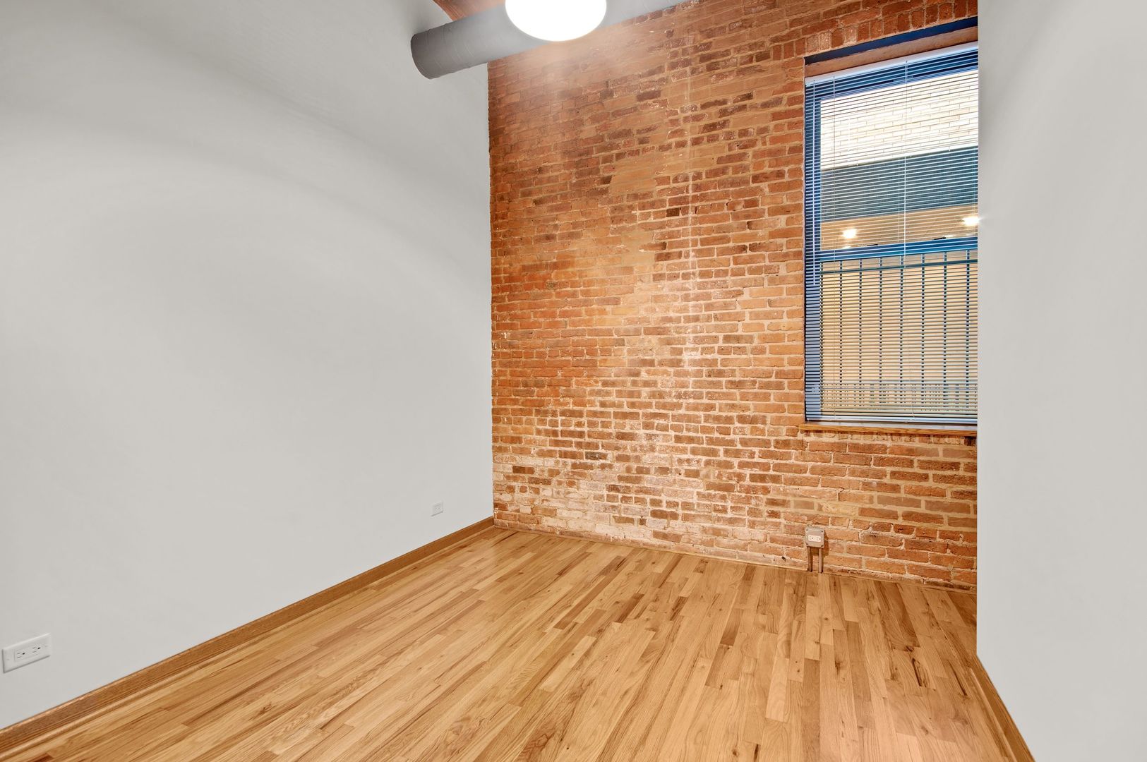 216 North May Street, Unit 101 Chicago, IL 60607 - Photo 12 of 19 a view of empty room with wooden floor