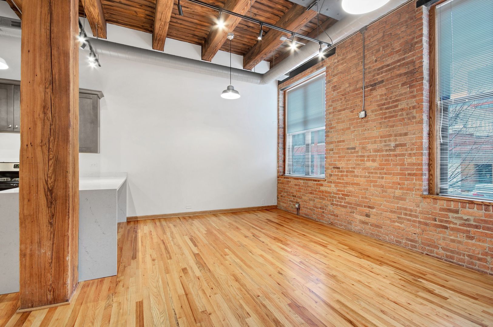 216 North May Street, Unit 101 Chicago, IL 60607 - Photo 5 of 19 a view of an empty room with wooden floor