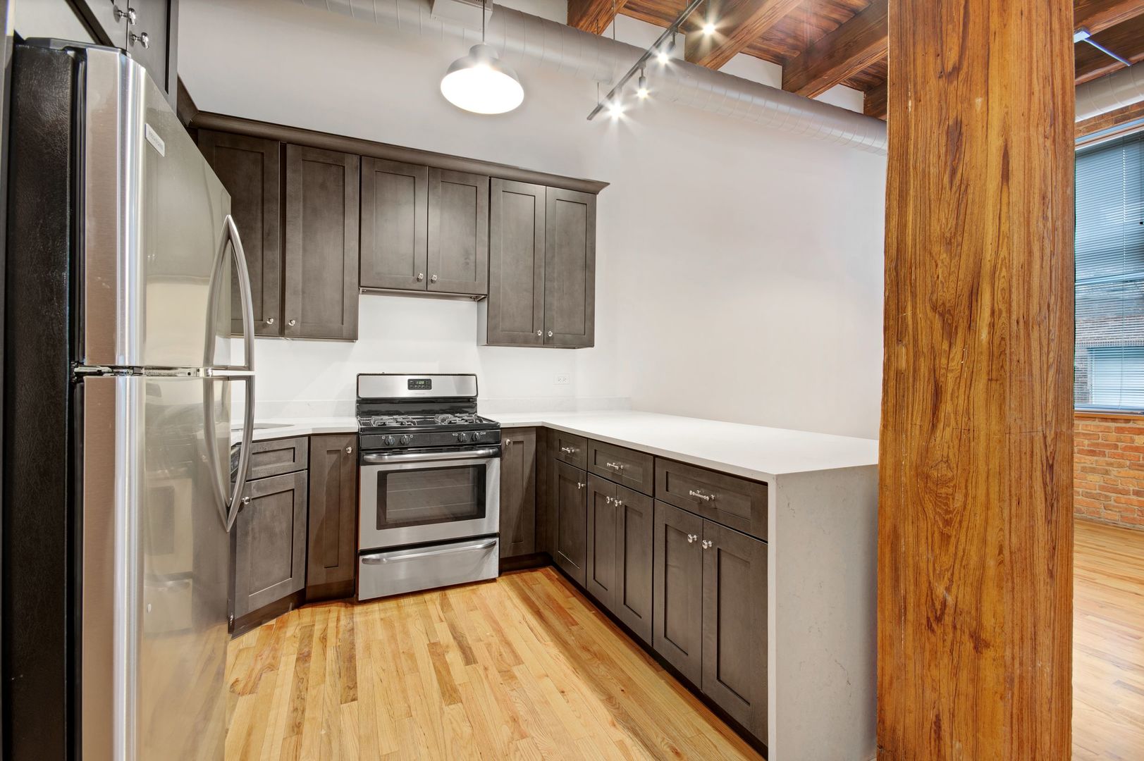 216 North May Street, Unit 101 Chicago, IL 60607 - Photo 6 of 19 a kitchen with a sink stove and refrigerator