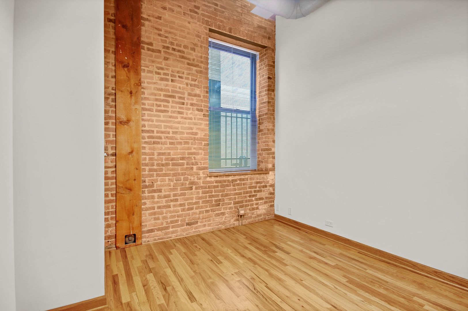 216 North May Street, Unit 101 Chicago, IL 60607 - Photo 10 of 19 a view of empty room with wooden floor and fan