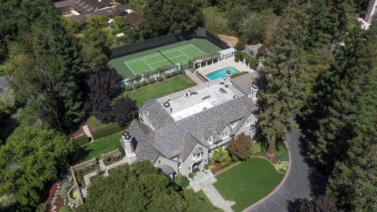 an aerial view of a house with a yard and outdoor seating