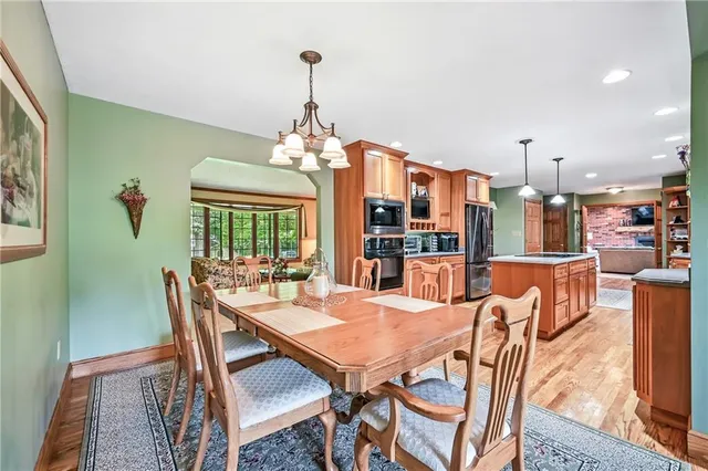 a view of a dining room with furniture wooden floor and chandelier