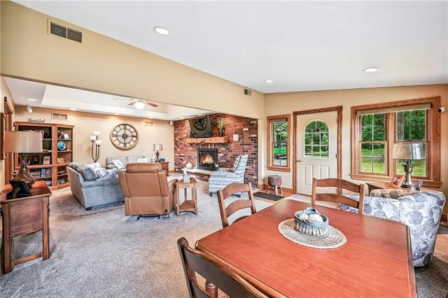 a living room with furniture a couch and large window