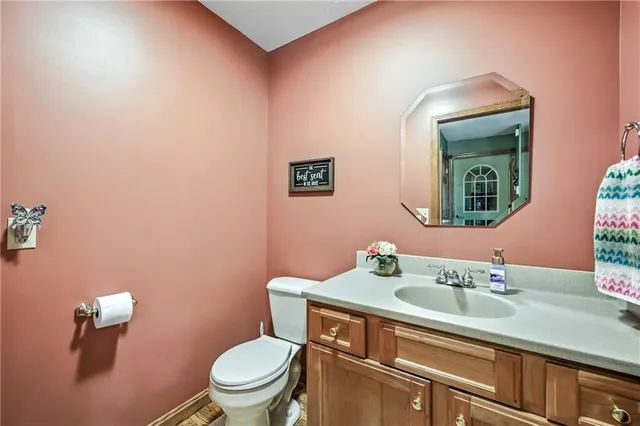 a bathroom with a toilet a sink and mirror
