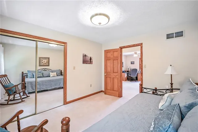 a bedroom with furniture and a wooden floor