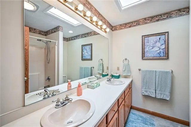 a bathroom with a double vanity sink and a mirror