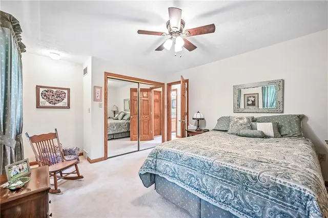 a bedroom with a large bed and a chandelier
