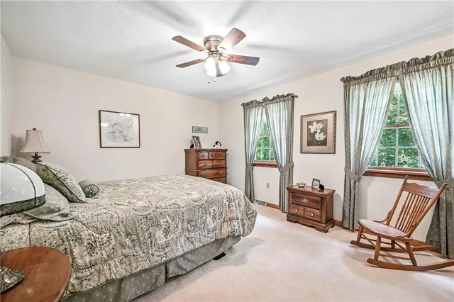 a bedroom with a bed chair and window