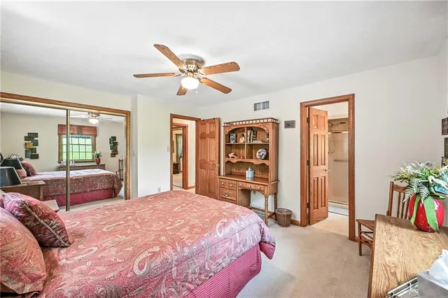 a bedroom with a bed dresser and a large window