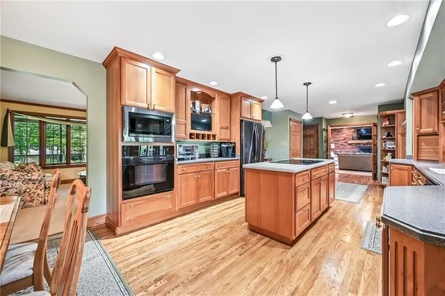 a large kitchen with stainless steel appliances kitchen island granite countertop a large counter top stainless steel appliances and cabinets