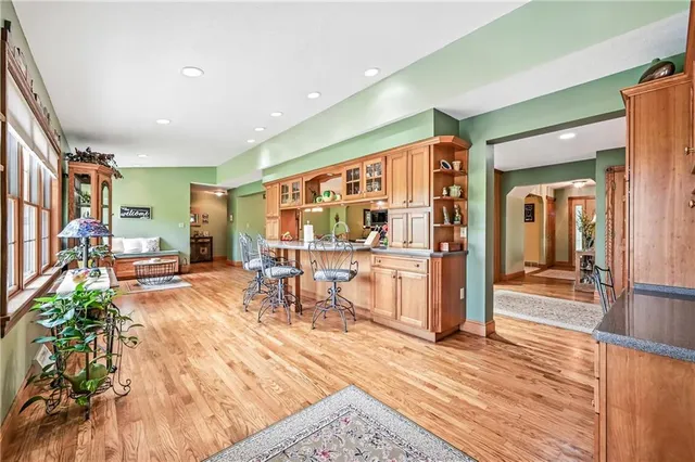 a living room with furniture a dining table and chairs with wooden floor
