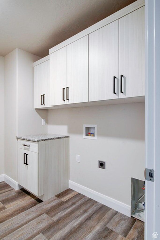 668 East Fiddlers Canyon Road, Unit 24 Cedar City, UT 84721 - Photo 15 of 21 Laundry area with washer hookup, cabinet space, light wood-style floors, and hookup for an electric dryer