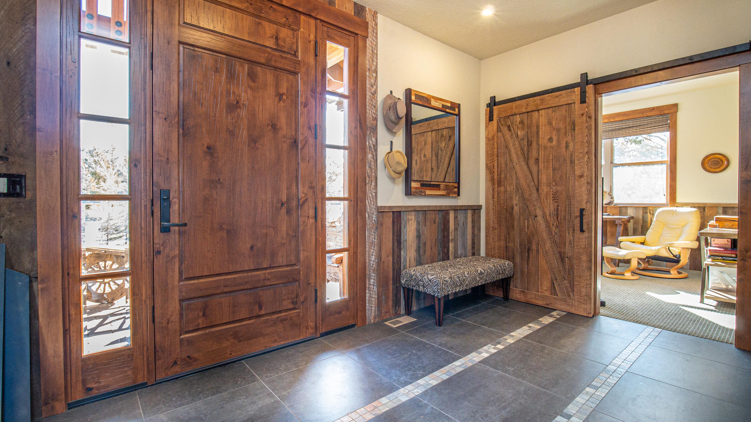 56988 Dancing Rock Loop Bend, OR 97707 - Photo 9 of 49 The tiled entry has a perfect den/home office with a sliding barn door just off of it.