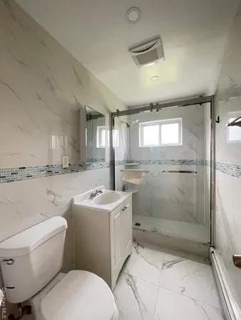 a bathroom with a sink toilet and shower