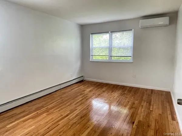 a view of an empty room and wooden floor