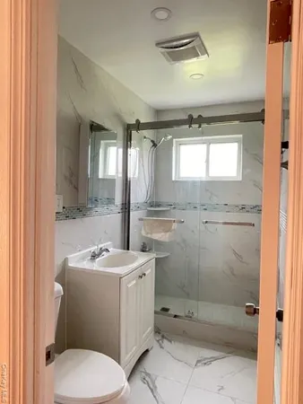a bathroom with a sink toilet and shower