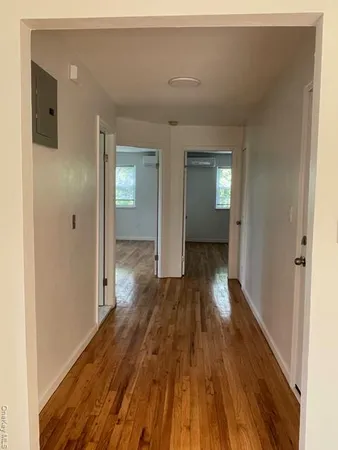 a view of hallway with wooden floor