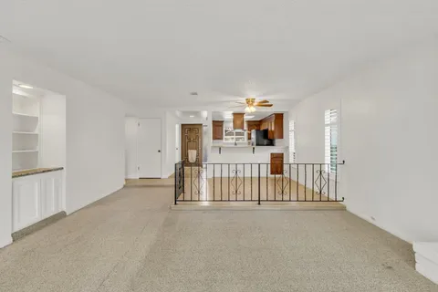 a view of a hallway with white doors