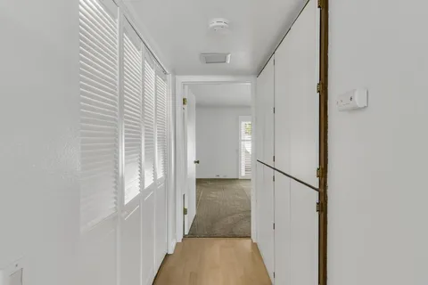 a view of a hallway with a white walls