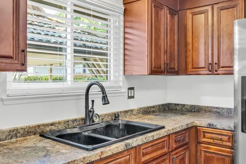 a kitchen with granite countertop a sink and a window