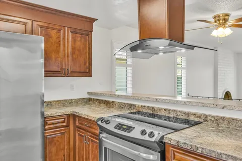 a view of a kitchen that has a sink a stove and a microwave