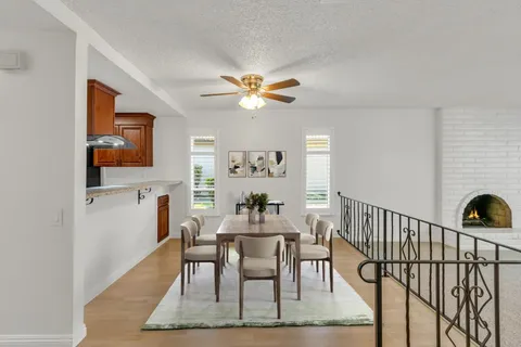 a dining room with furniture a rug and a chandelier