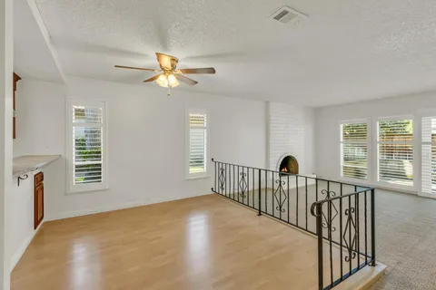 a view of a bedroom with wooden floor