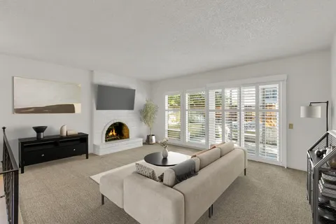 a living room with furniture and a floor to ceiling window