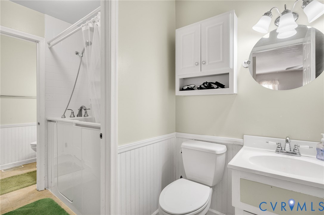 8994 Becton Road Glen Allen, VA 23060 - Photo 22 of 29 Bathroom with vanity and wainscoting