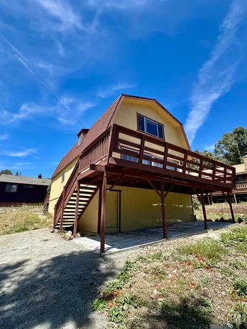 a view of a roof deck with wooden fence