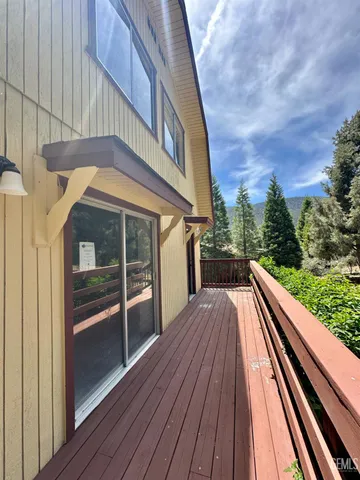a view of balcony with a large window and wooden floor