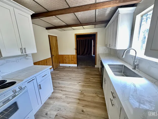 a kitchen with sink and cabinets