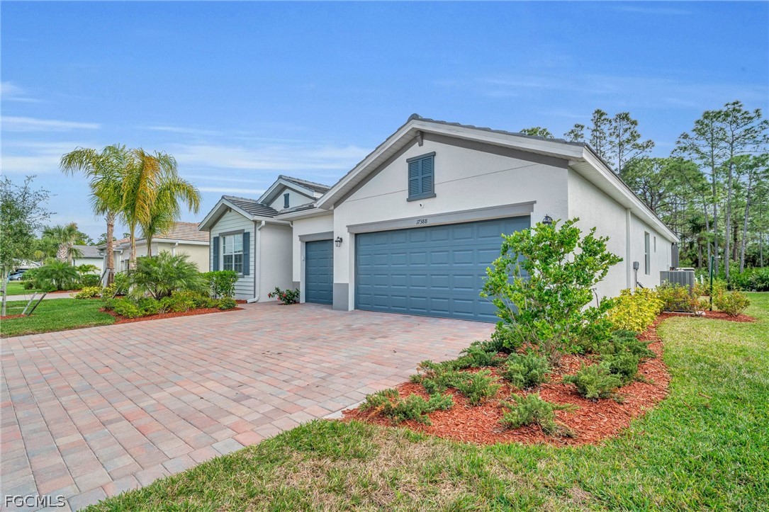 17388 Walnut Run Drive Alva, FL 33920 - Photo 22 of 24 a view of a house with a small yard and plants