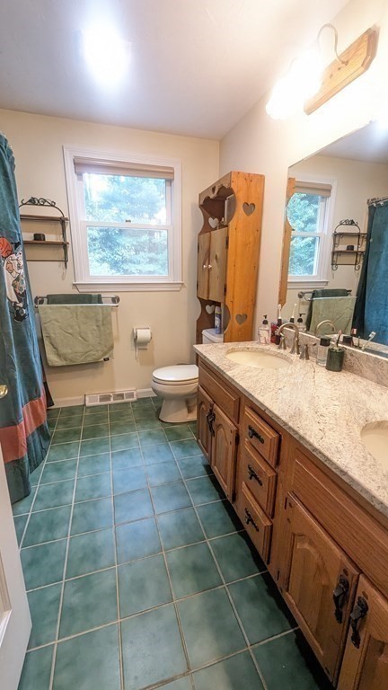 10 Van Gemert Drive Mansfield, MA 02048 - Photo 17 of 33 a spacious bathroom with a granite countertop sink a toilet and a mirror