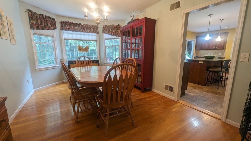 10 Van Gemert Drive Mansfield, MA 02048 - Photo 10 of 33 a view of a dining room with furniture and a floor to ceiling window