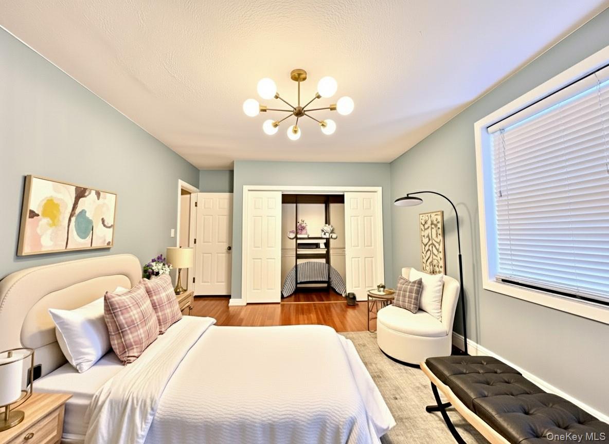 96-11 65th Road, Unit 1 Queens, NY 11374 - Photo 4 of 10 a bedroom with a bed and a chandelier