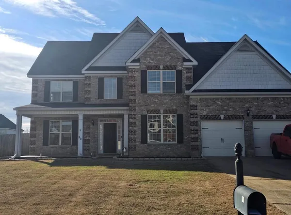 a front view of a house with a yard