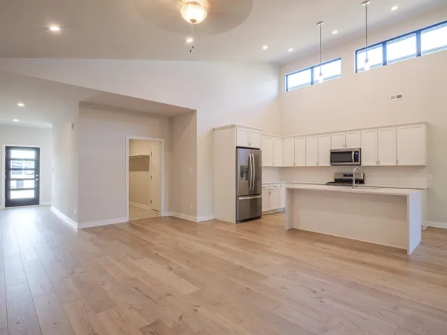 a view of kitchen with stainless steel appliances refrigerator oven and microwave