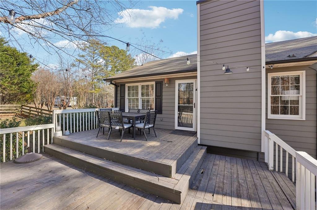 1600 Mountain Trace Canton, GA 30114 - Photo 32 of 50 a view of a house with wooden deck and furniture