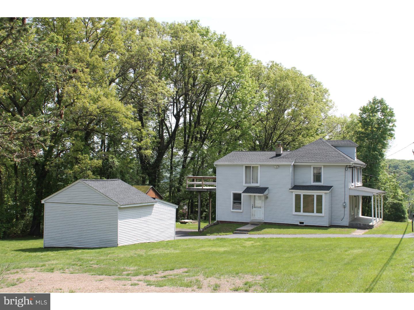 1724 Ramich Road Temple, PA 19560 - Photo 20 of 25 a white house with a big yard plants and large trees